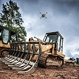 Microdrones md4-3000 mdLiDAR3000 performing a Laser scan of a construction site, flying over a bulldozer