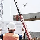 Architect inspecting a construction site with the help of a Microdrones UAV