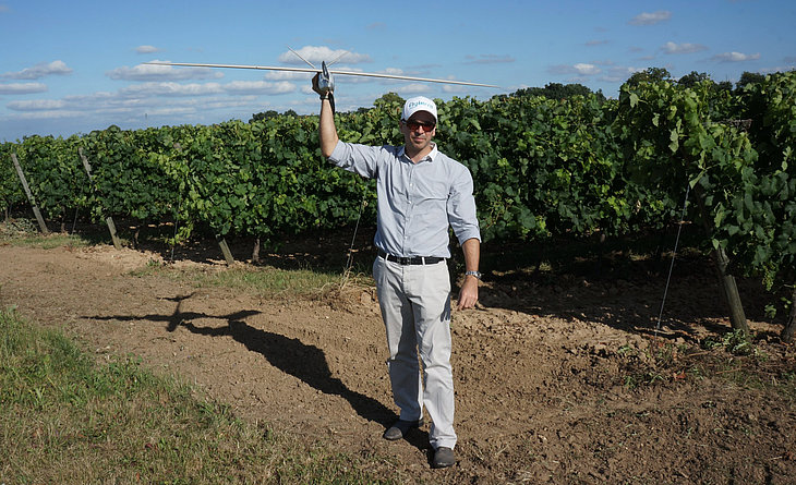 Vivien Heriard-Dubreuil, Microdrones president, holding a model aircraft ready to inspect a vineyard.
