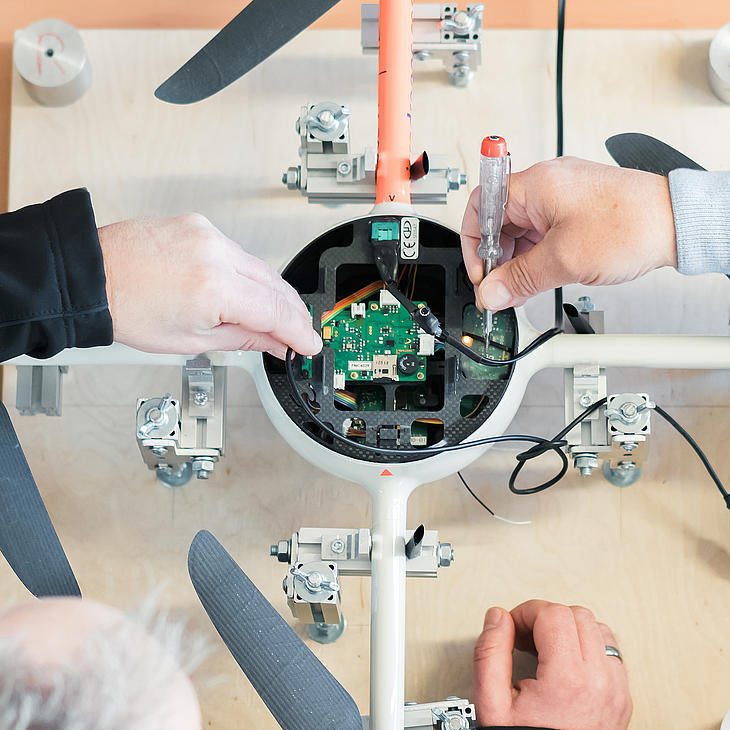 Microdrones engineers preparing md4-200 electronics for new mission